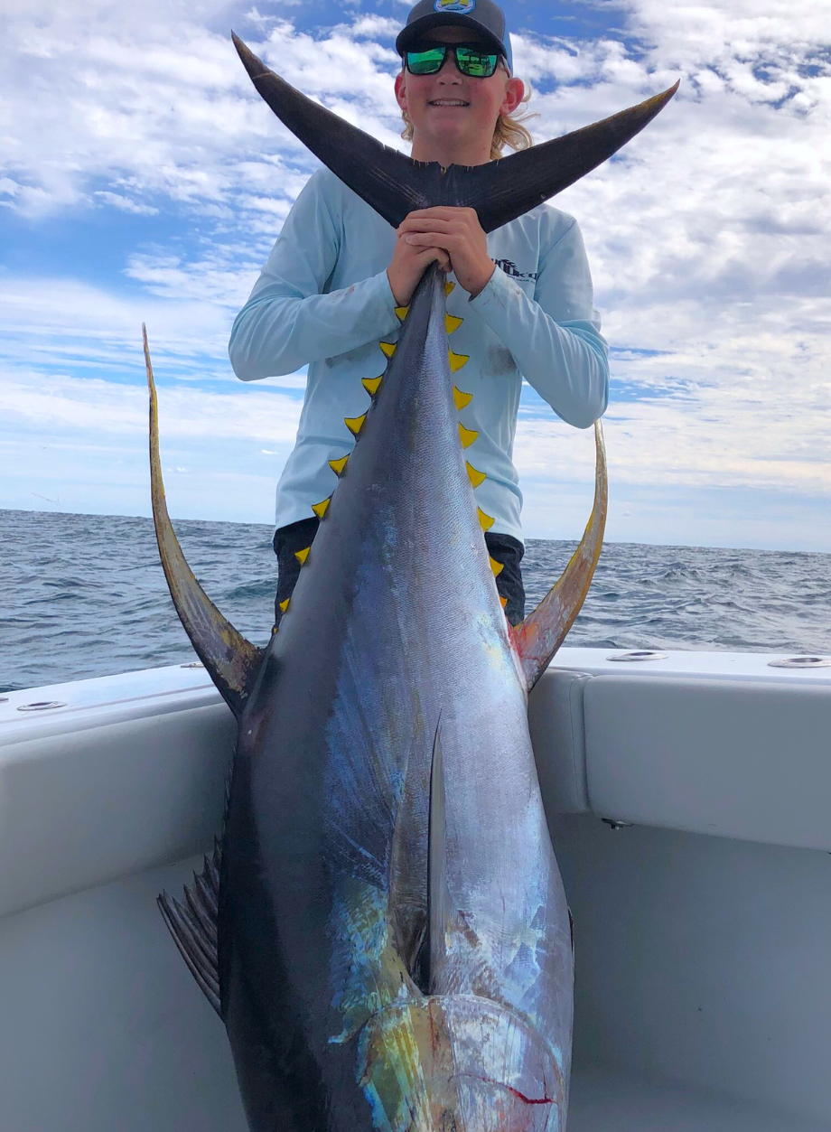 Young man with a nice yellowfin tuna