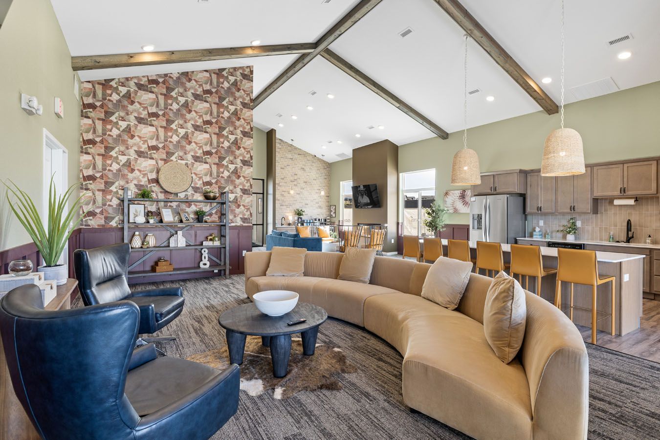 a living room with a couch , chairs , and a table .