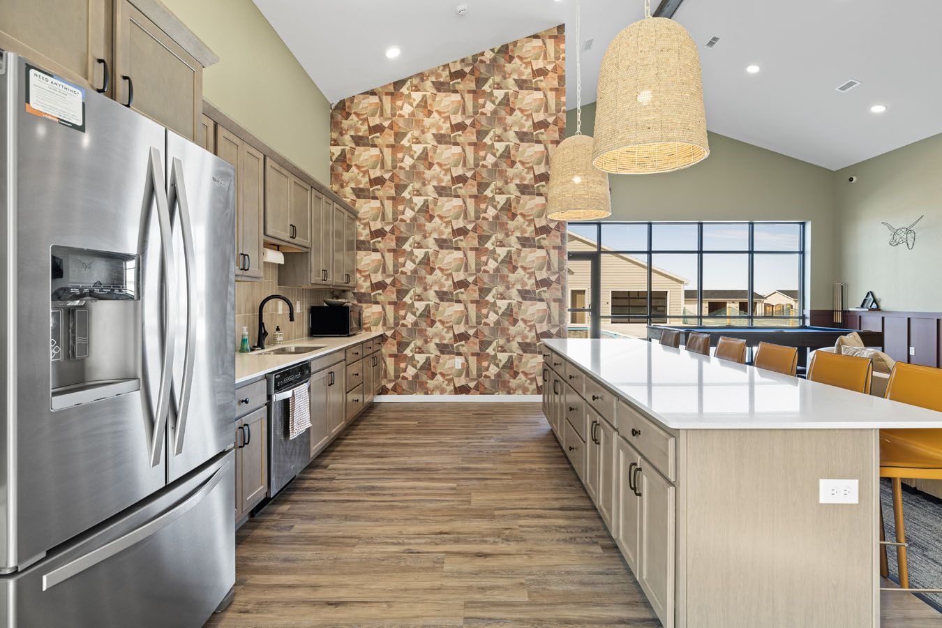 a kitchen with stainless steel appliances and a large island .