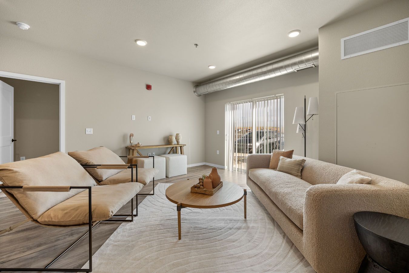 a living room with a couch , chairs , and a coffee table .