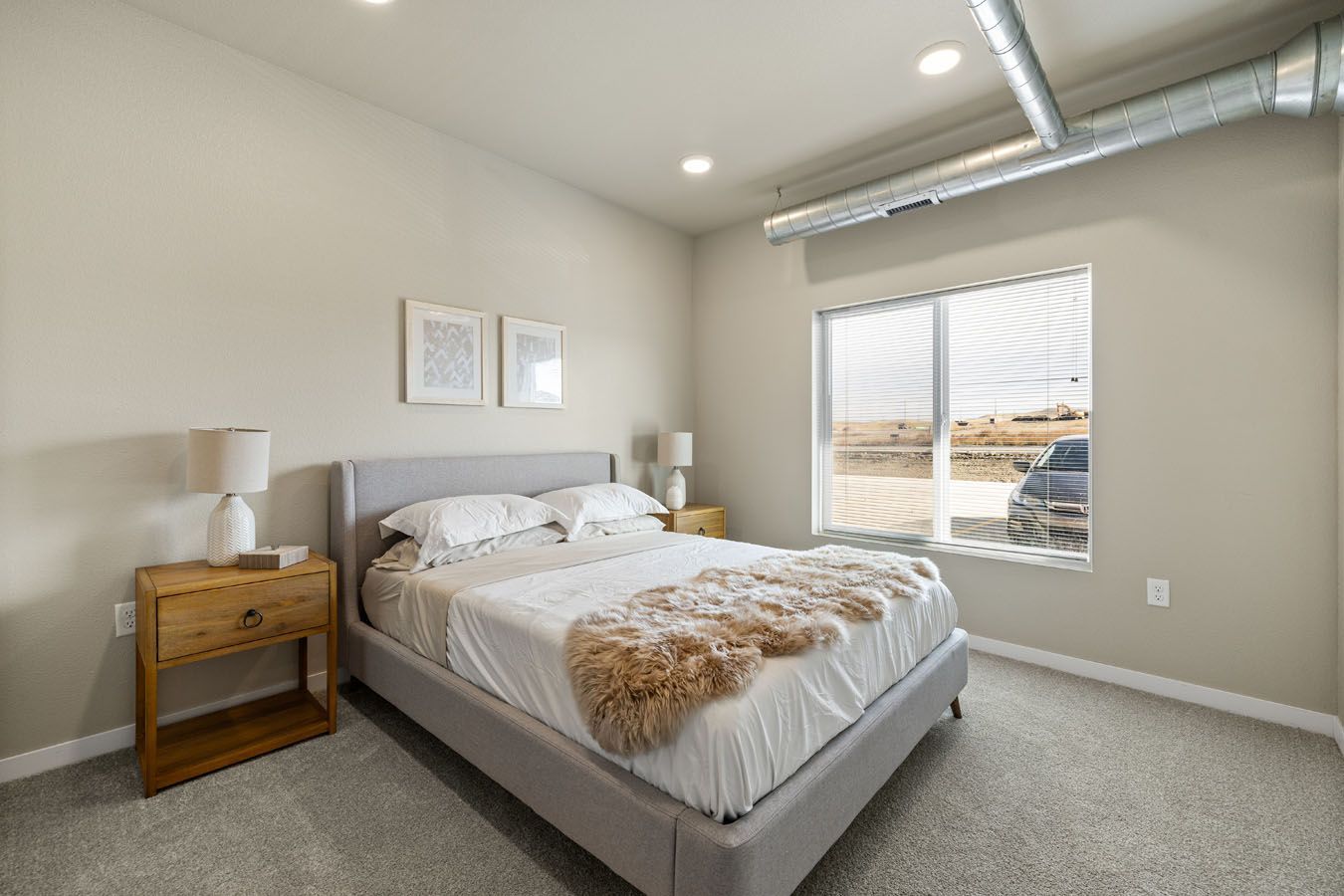 a bedroom with a bed , nightstand , and window .