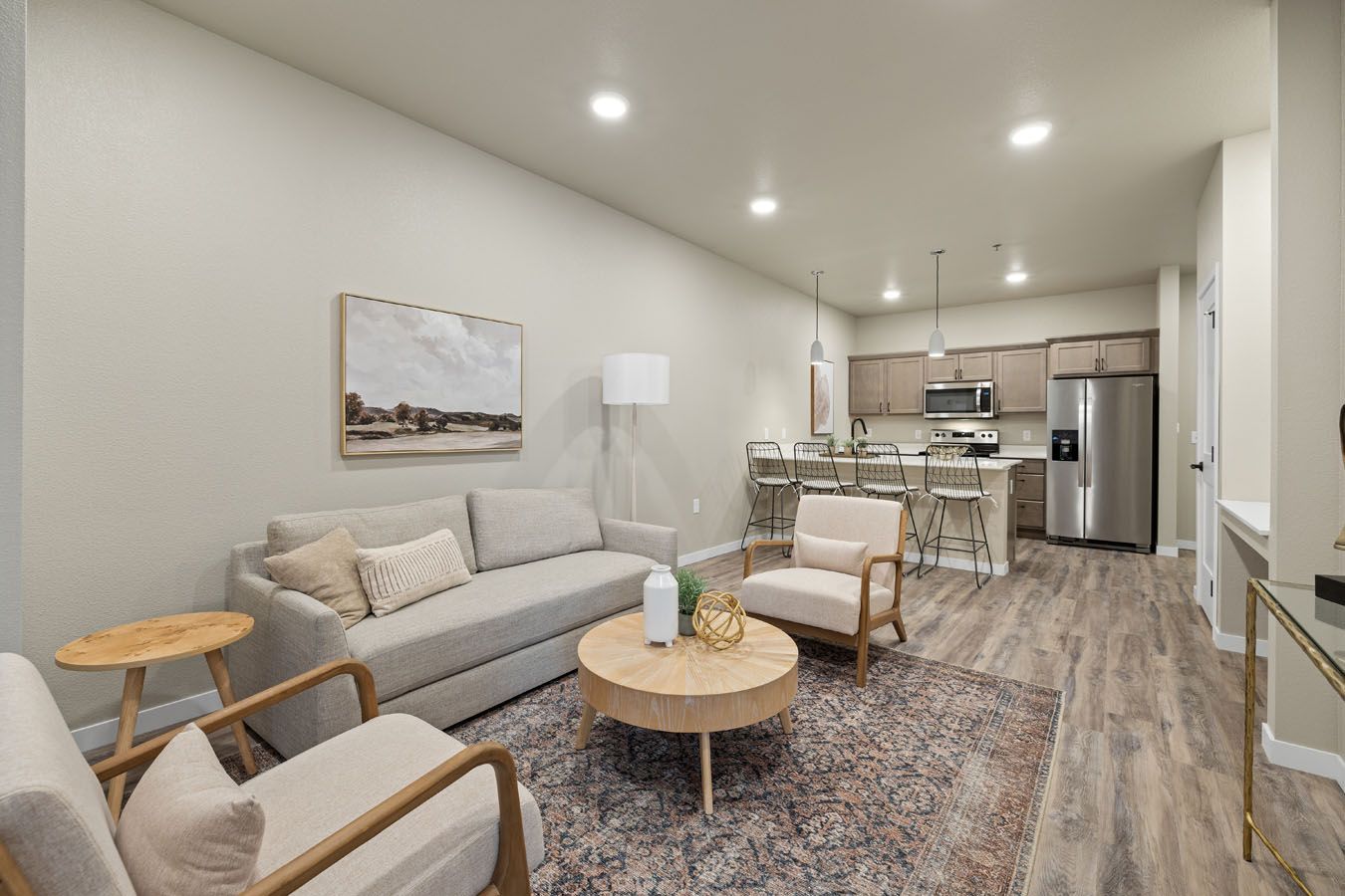 a living room with a couch , chairs , and a coffee table .