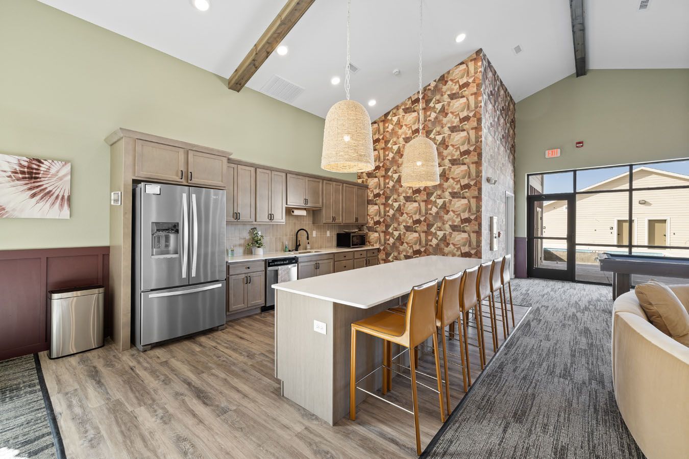 a kitchen with stainless steel appliances and a large island in a living room .