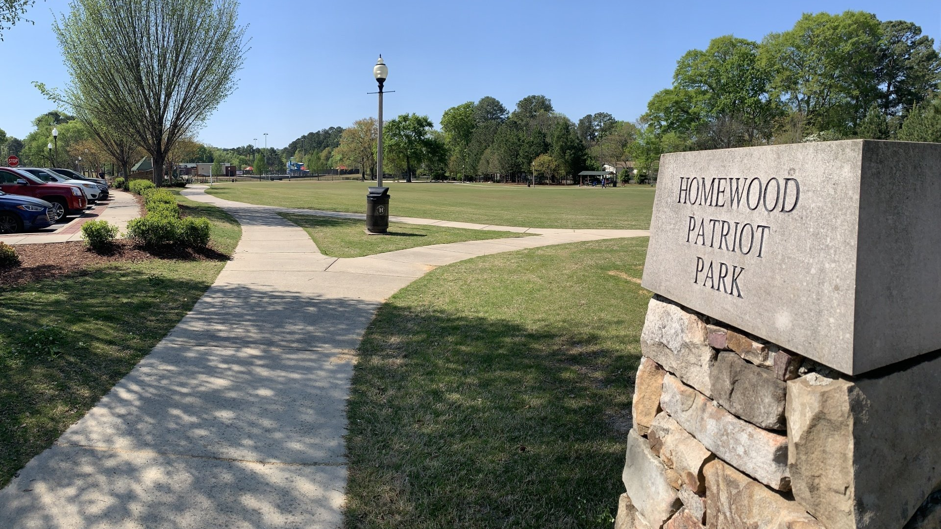 There is a stone sign in the middle of the park.