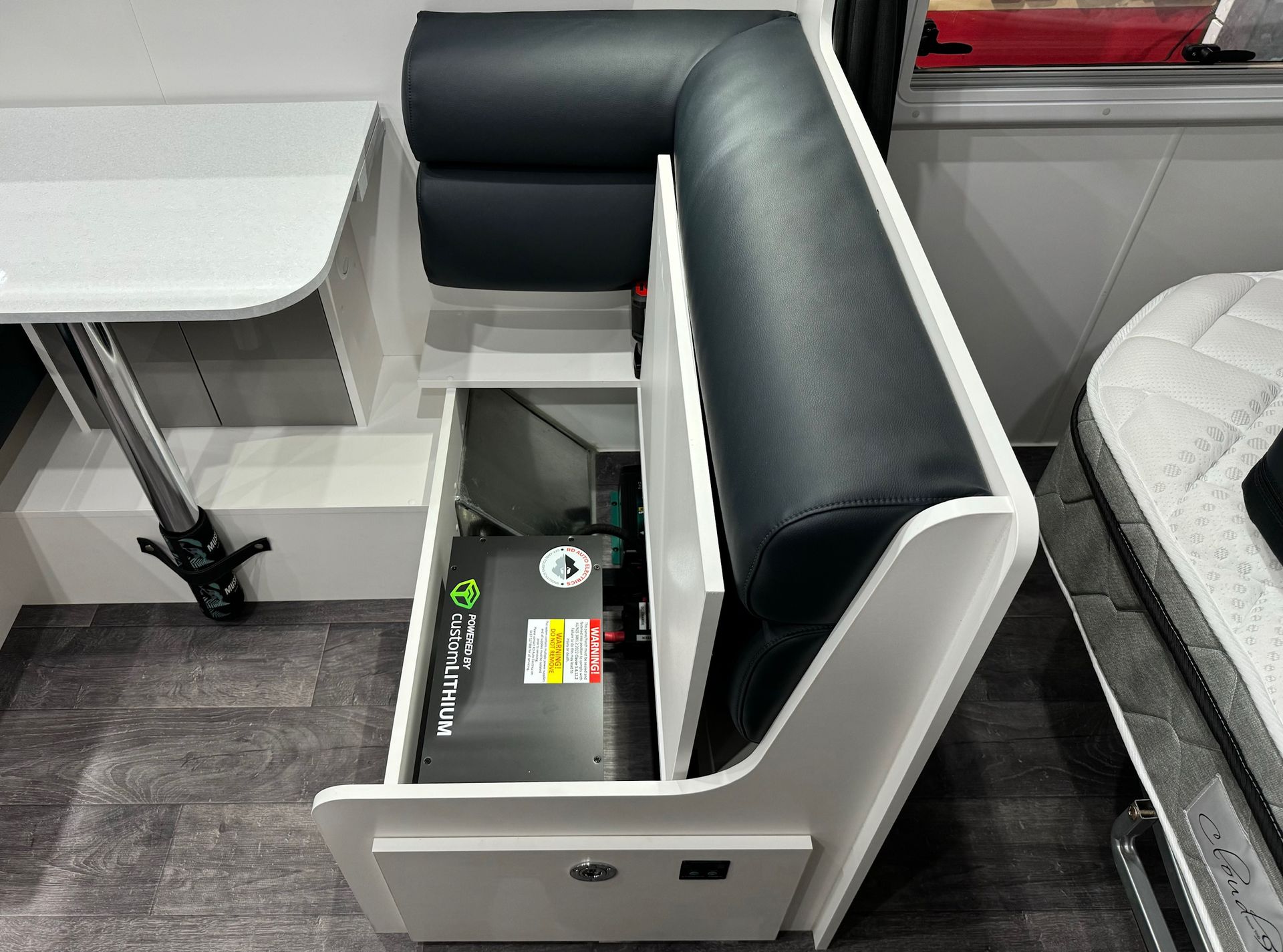 Space-saving under-seat caravan lithium battery installation for off-grid power and efficient energy use.