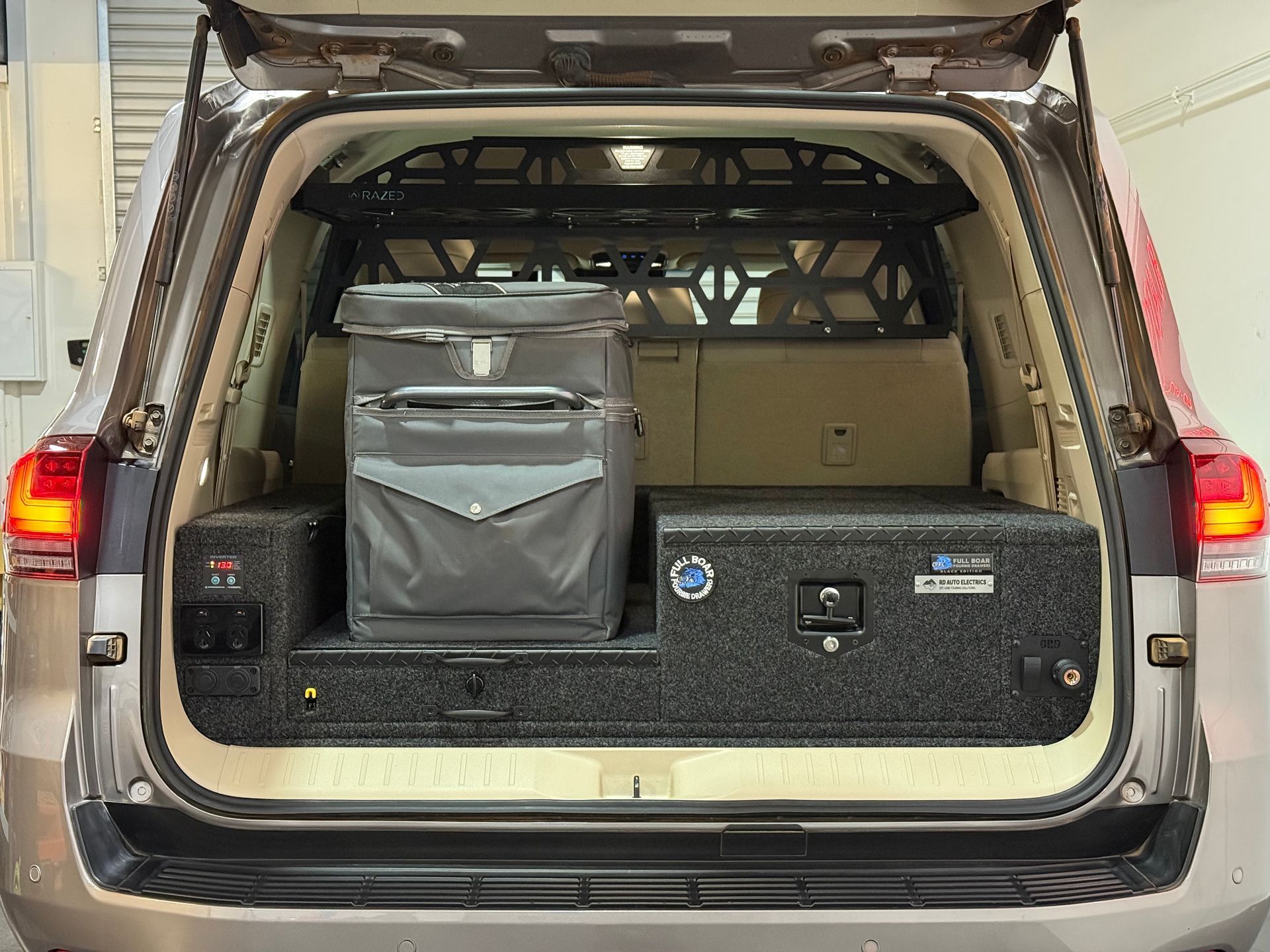 Toyota LandCruiser rear drawer system with fridge slide and 12V power outlets for off-grid touring and camping.