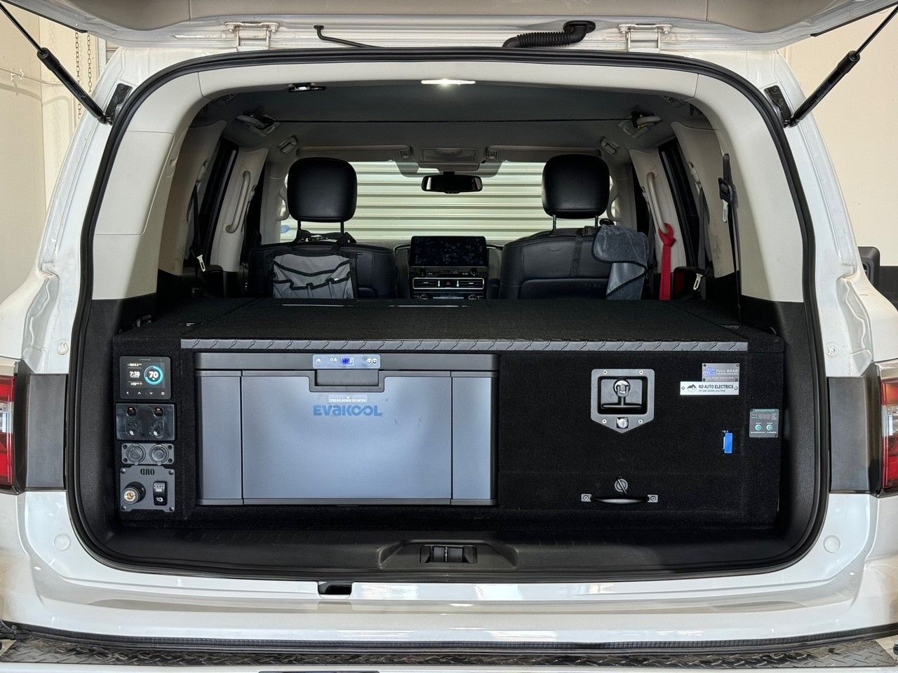 4WD rear drawer system with integrated Evakool fridge and 12V power setup installed in a touring vehicle for off-grid camping
