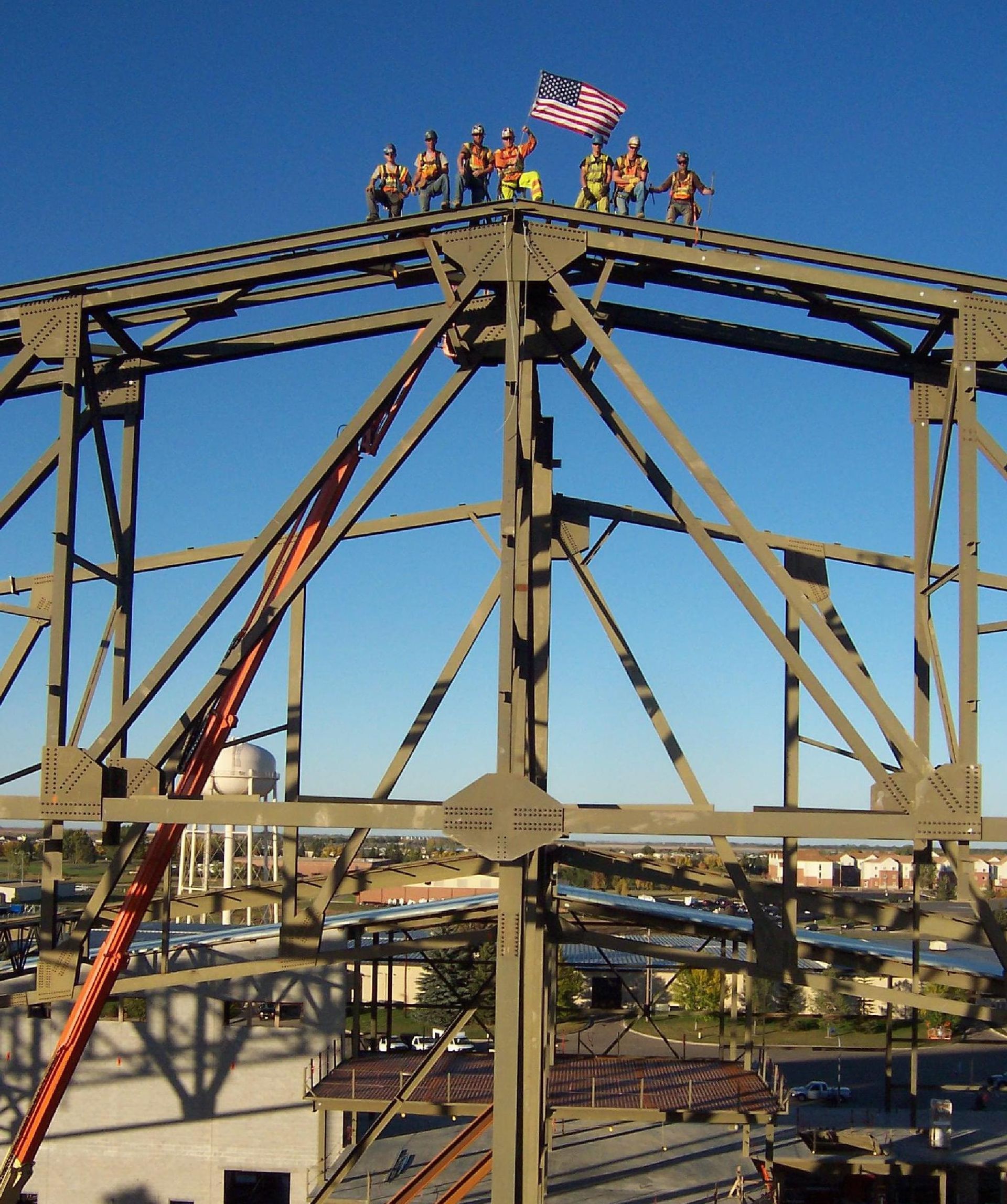 Matt O'Donnell  standing on top of a bridge holding an American flag