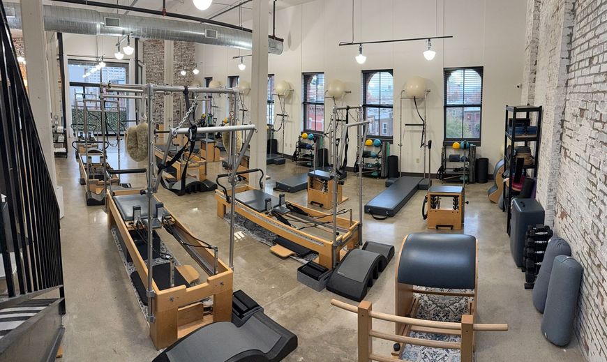 Interior of Project Pilates studio in Jersey City, NJ, featuring Balanced Body Reformers, Towers, and Pilates equipment in a spacious, naturally lit setting.