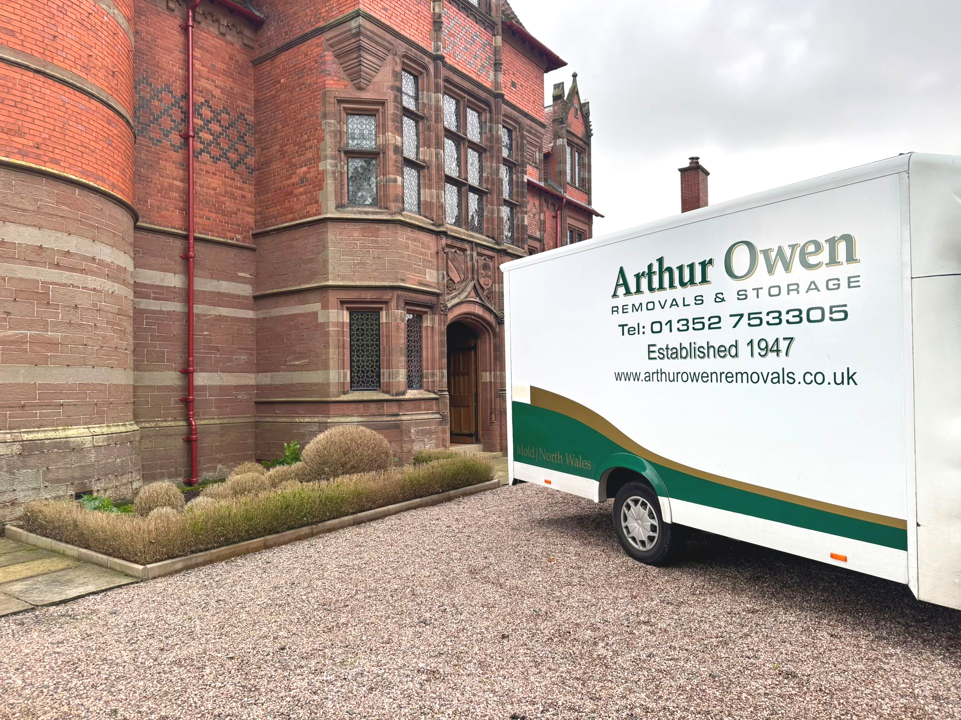 Arthur Owen Removals & Storage van parked on a gravel driveway in front of Eccleston Paddocks.