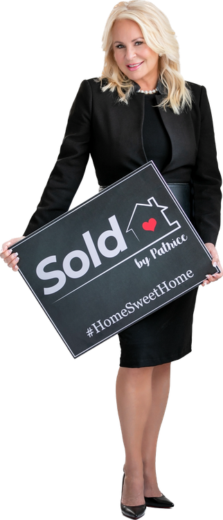 A woman in a black dress is holding a sold sign.