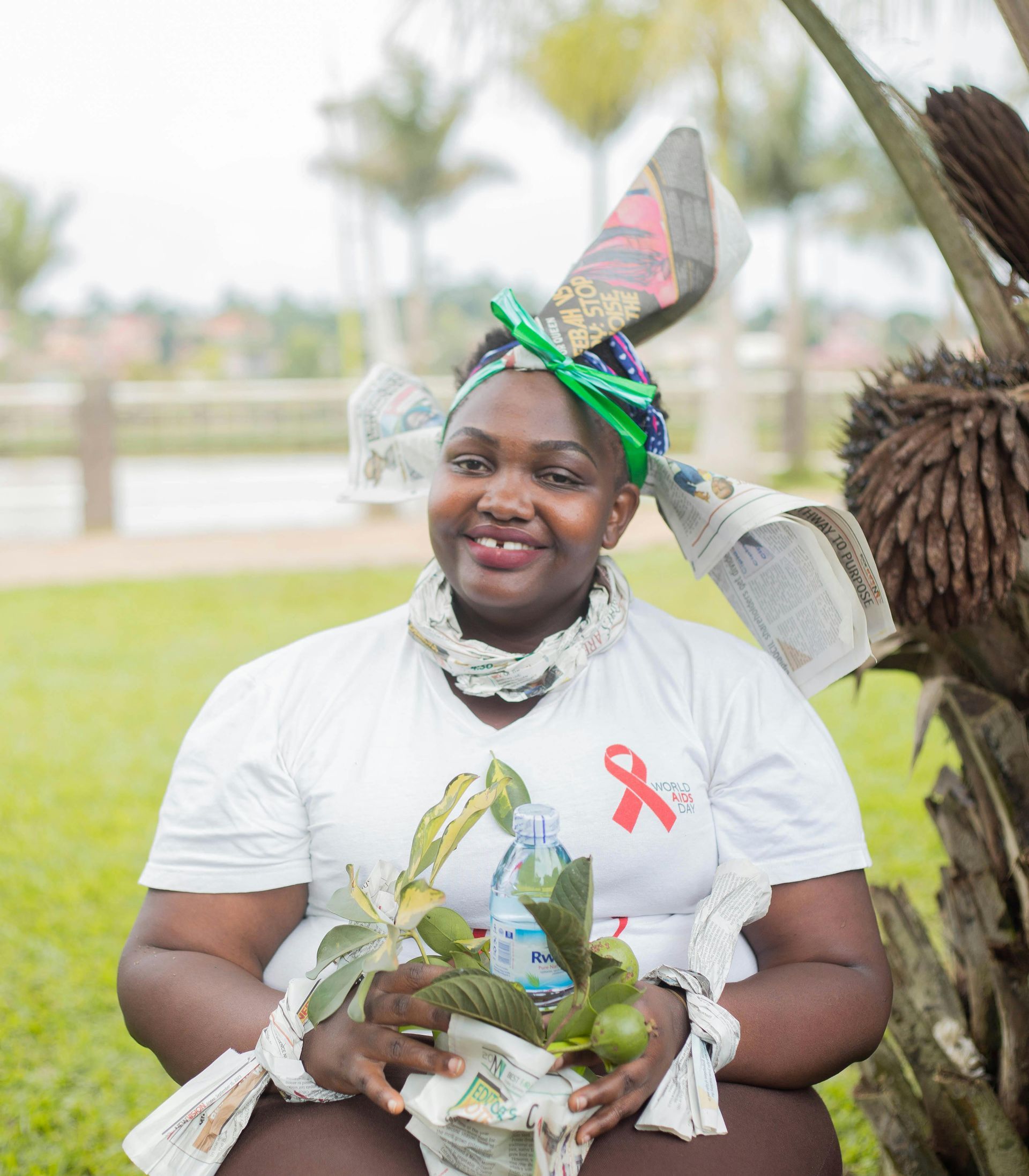 A woman wearing a white shirt with a red ribbon on it