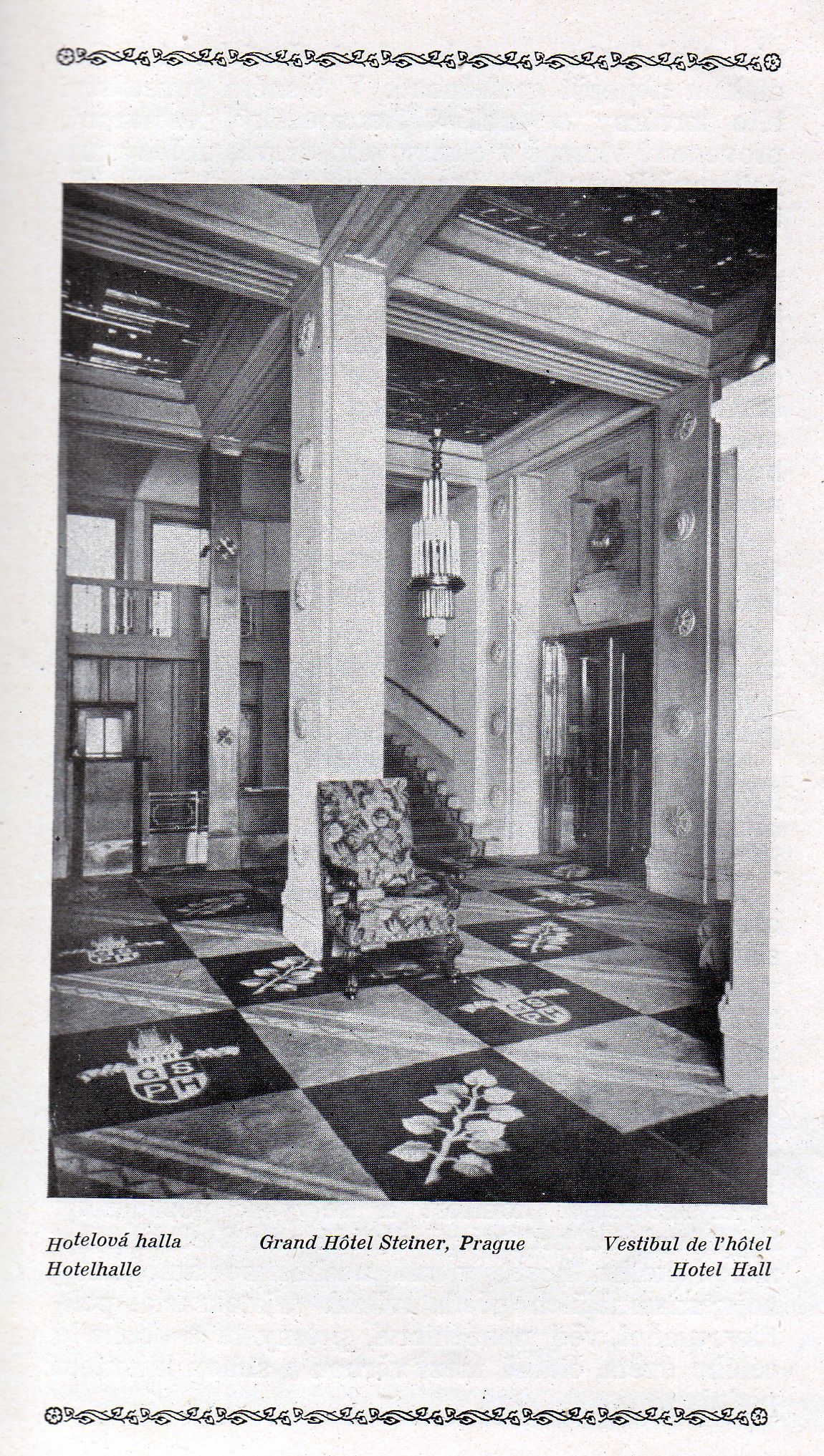 Black-and-white photo of a tiled interior with columns, beams, and a checkered floor in a historic room