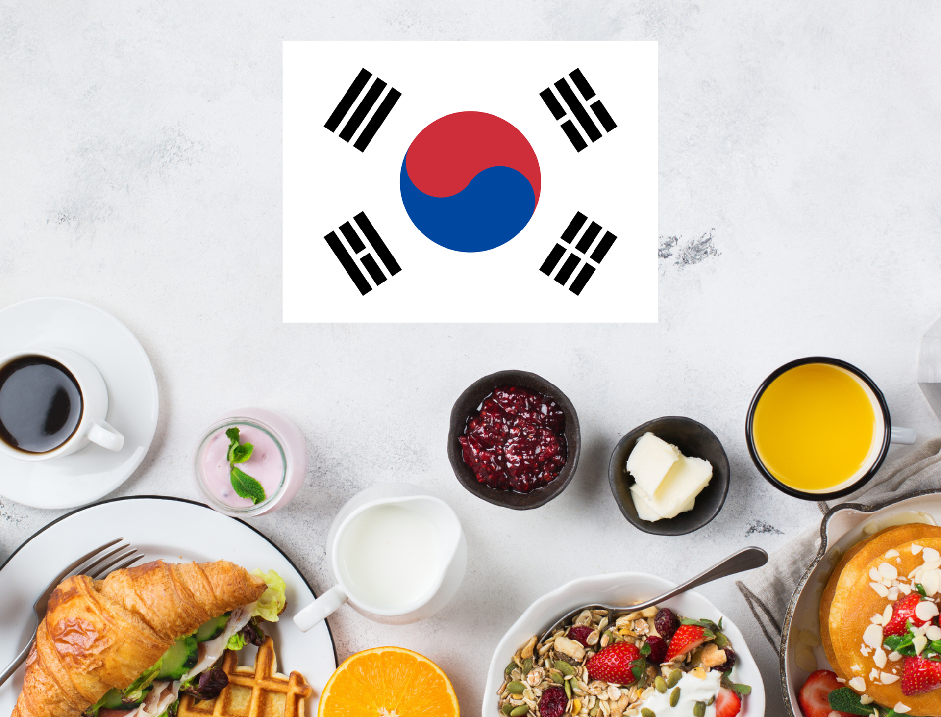 South Korean flag above a breakfast table with coffee, fruit, and pastries