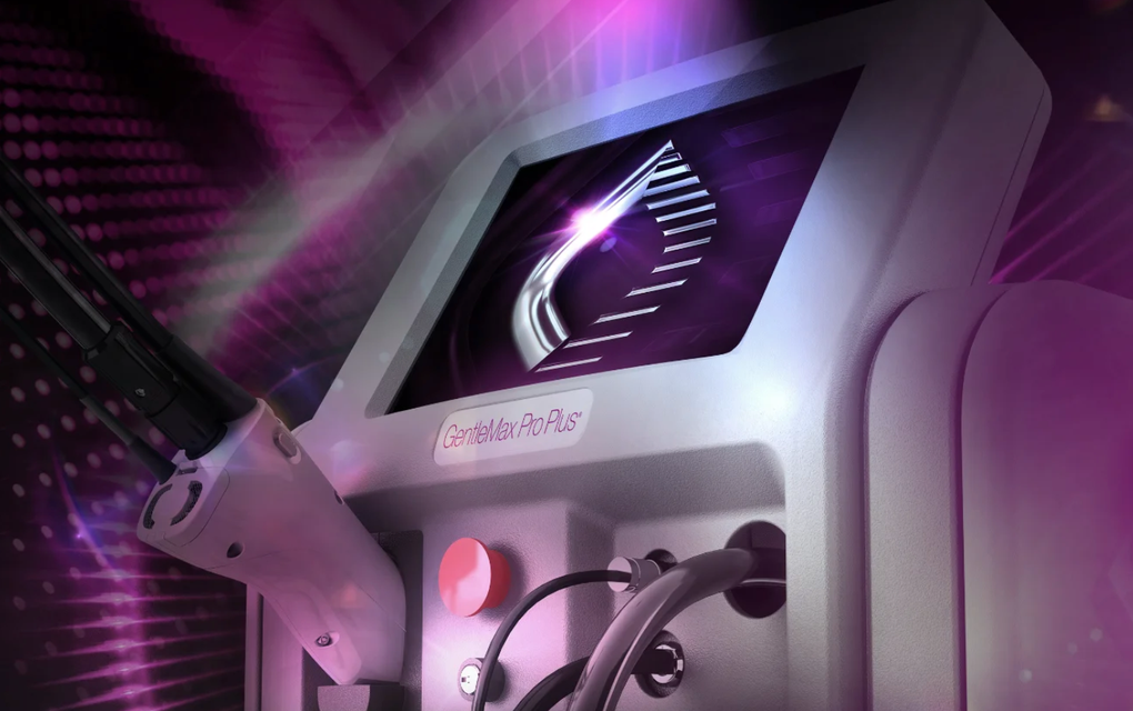 Futuristic machine console glowing purple with cables and a bright display screen