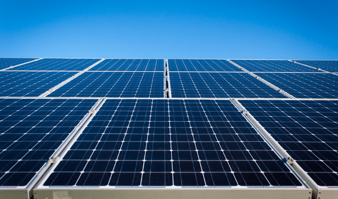 Solar panels against a clear blue sky.