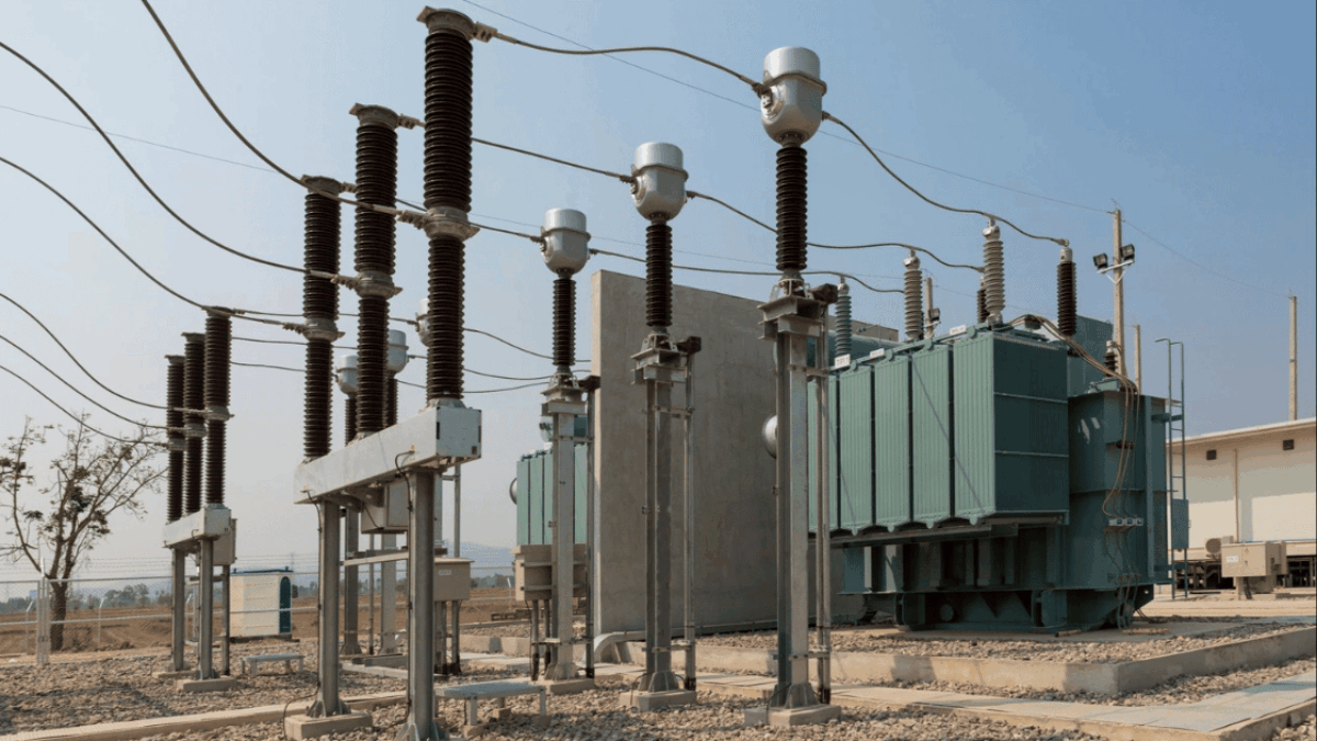 Electrical power substation with transformers, insulators, and overhead power lines.
