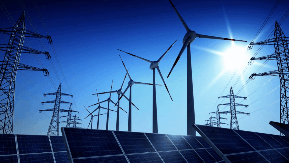 Wind turbines and solar panels generate electricity under a blue sky, with power lines in the foreground.