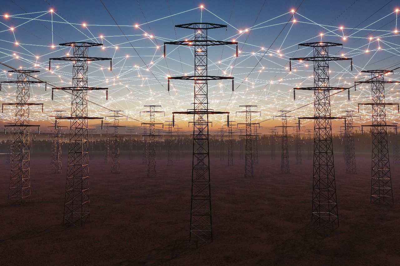 Power lines silhouetted against a dusk sky, connected by glowing digital network lines.
