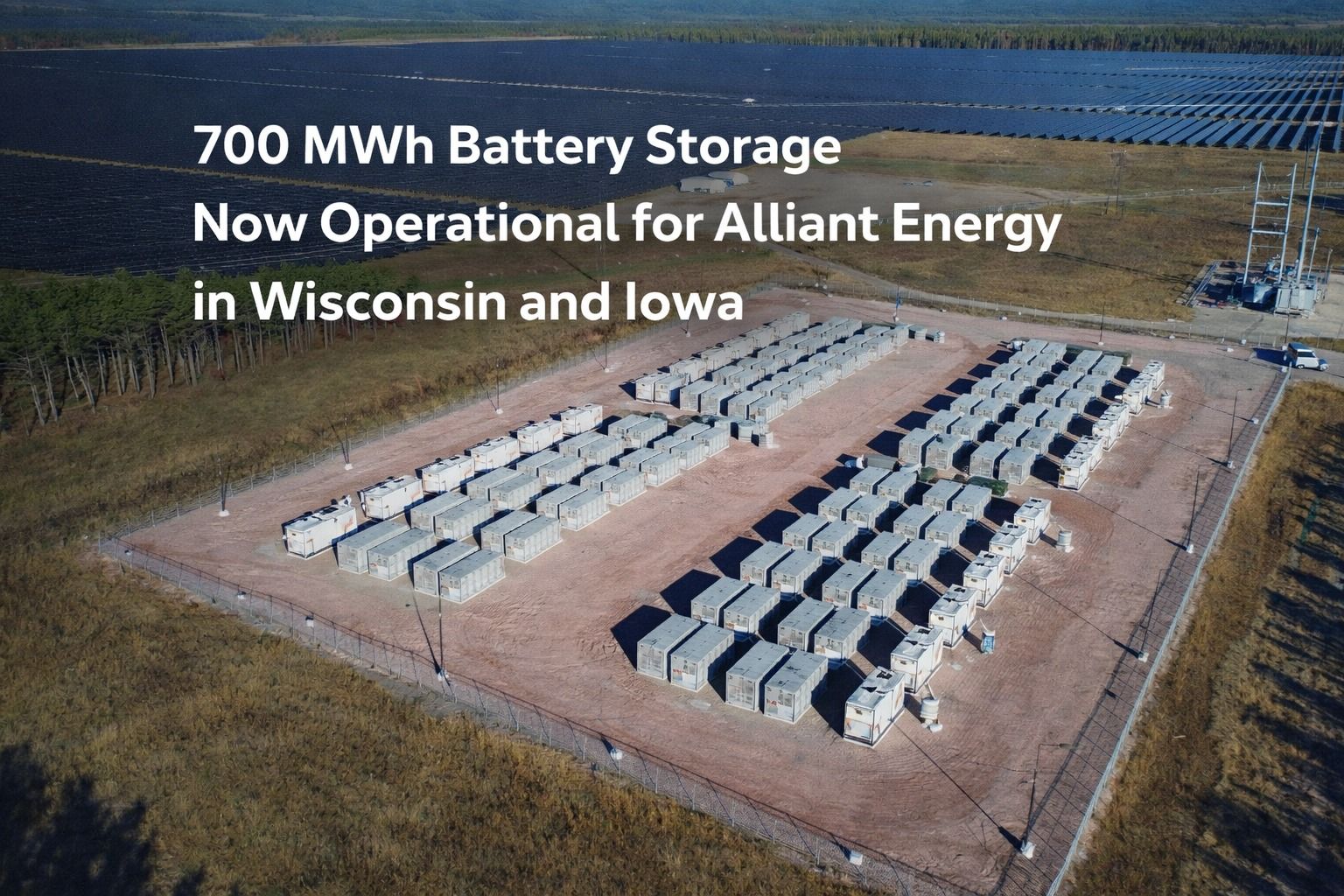 Aerial view of a large-scale 700 MWh battery energy storage facility with grid-connected solar panels, now operational for Alliant Energy in Wisconsin and Iowa.