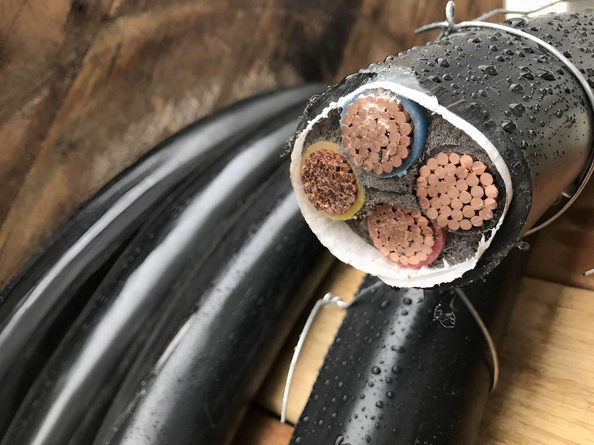 A Close Up Of A Black Cable With Copper Wires In Underground — CQ Service Locating In Rockhampton, QLD