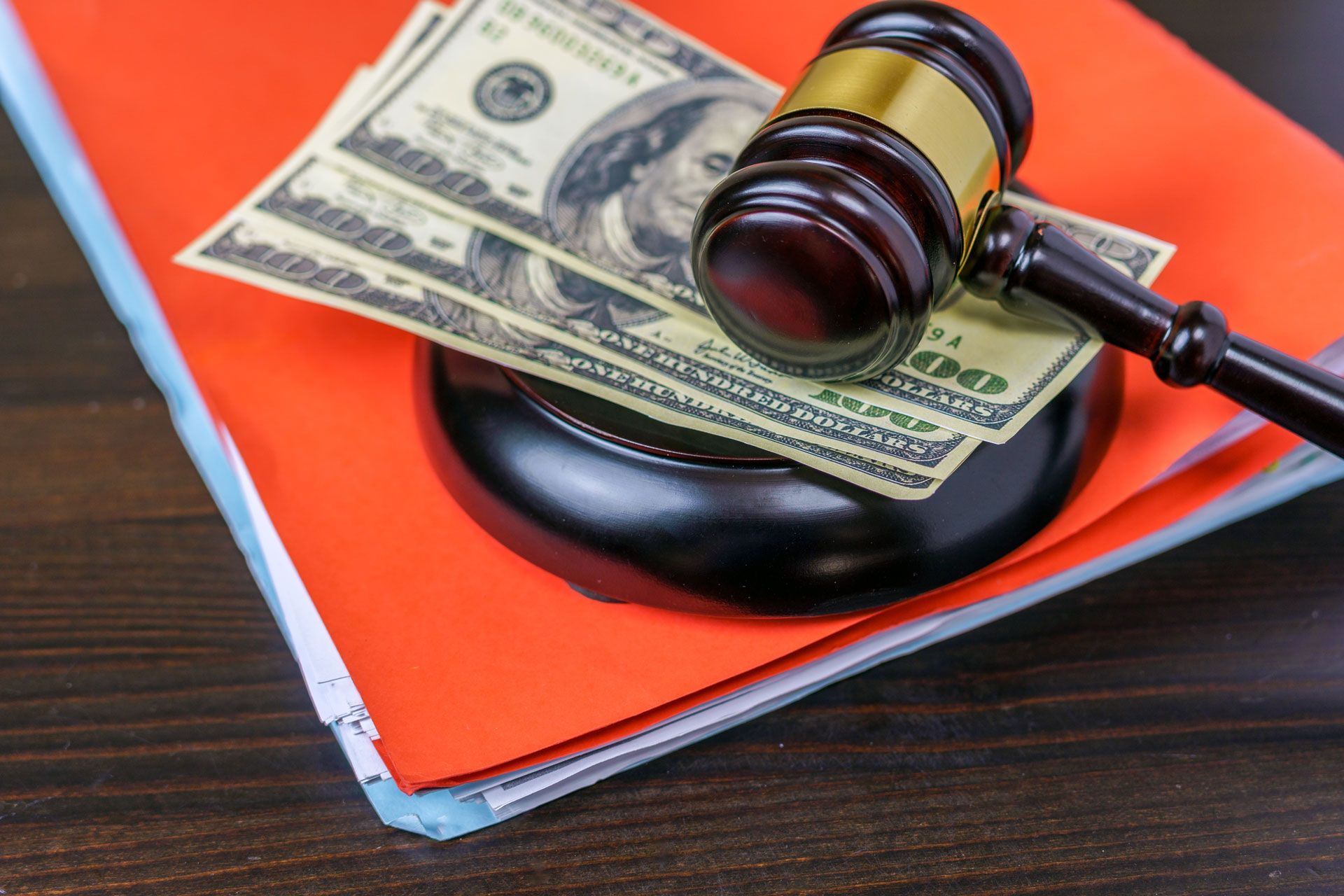 A judge 's gavel is sitting on top of a pile of money