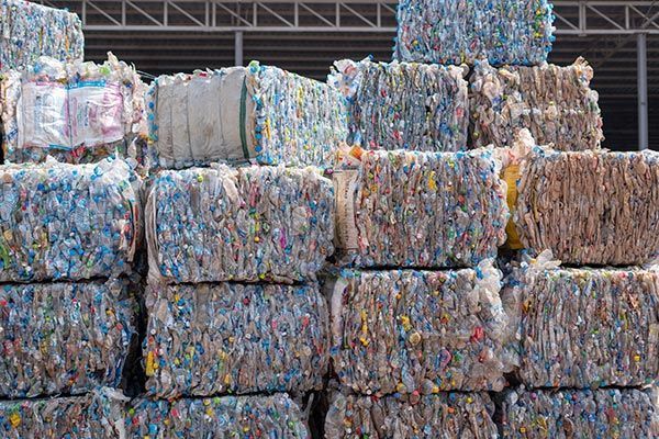 A pile of plastic bottles stacked on top of each other. A pile of plastic bottles stacked on top of each other.