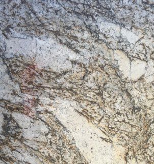 Close-up of a gray and tan marbled rock surface with dark vein-like patterns