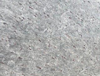 Close-up of a light gray speckled concrete surface