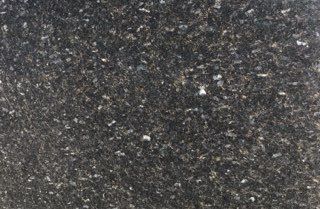 Close-up of a dark gray speckled stone surface with small white flecks
