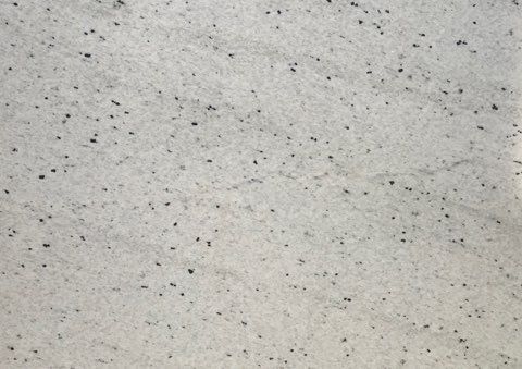Light gray speckled surface texture with small black flecks