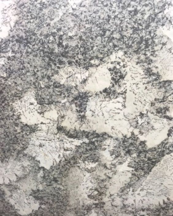 Abstract gray and white marbled stone texture with mottled speckles