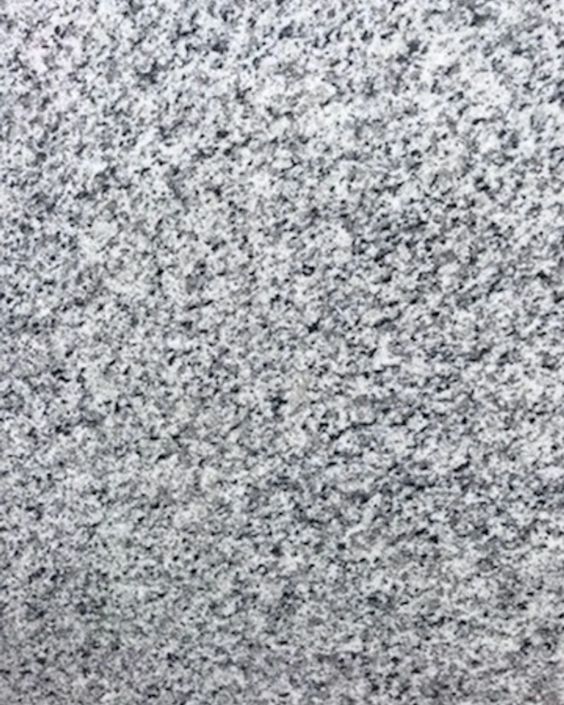 Close-up of gray speckled stone texture with black and white flecks