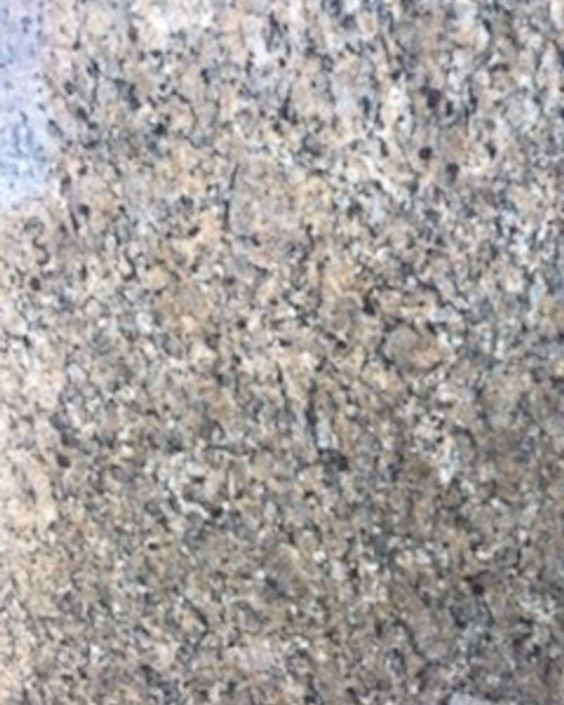 Close-up of a speckled gray, beige, and black stone surface