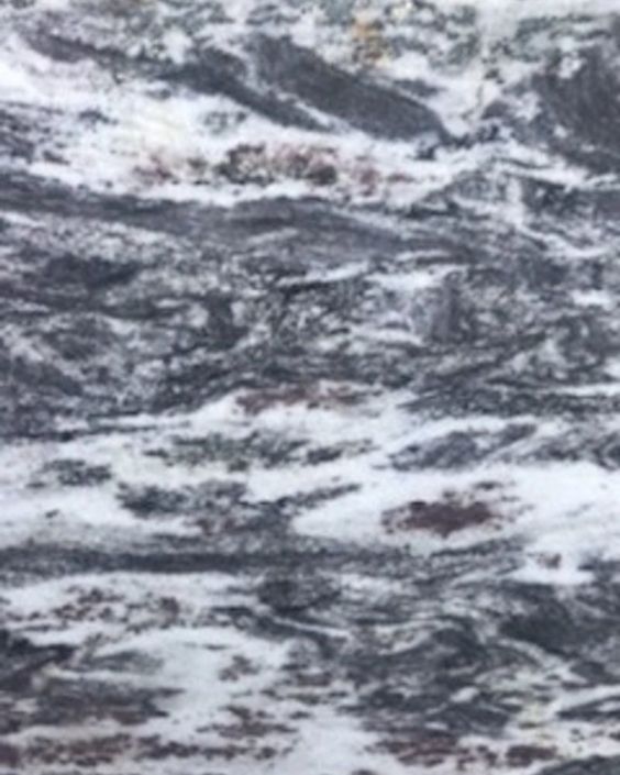 Close-up of a gray and white marbled stone texture with wavy veining
