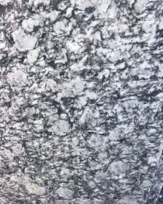 Gray and white speckled stone surface with a rough, mottled texture