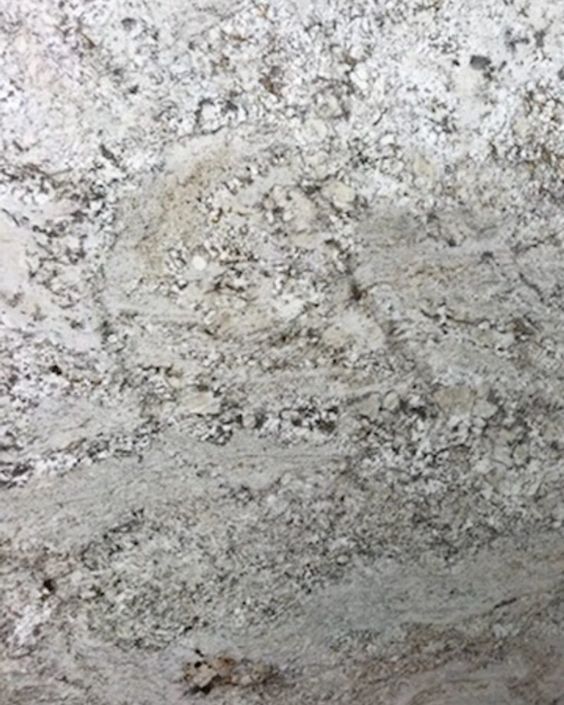Close-up of a rough, light gray stone wall with mottled white and dark speckles