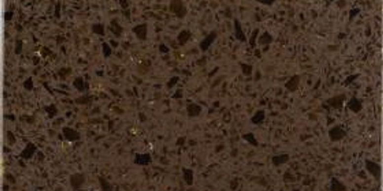 Close-up of speckled brown terrazzo or stone surface with small dark flecks