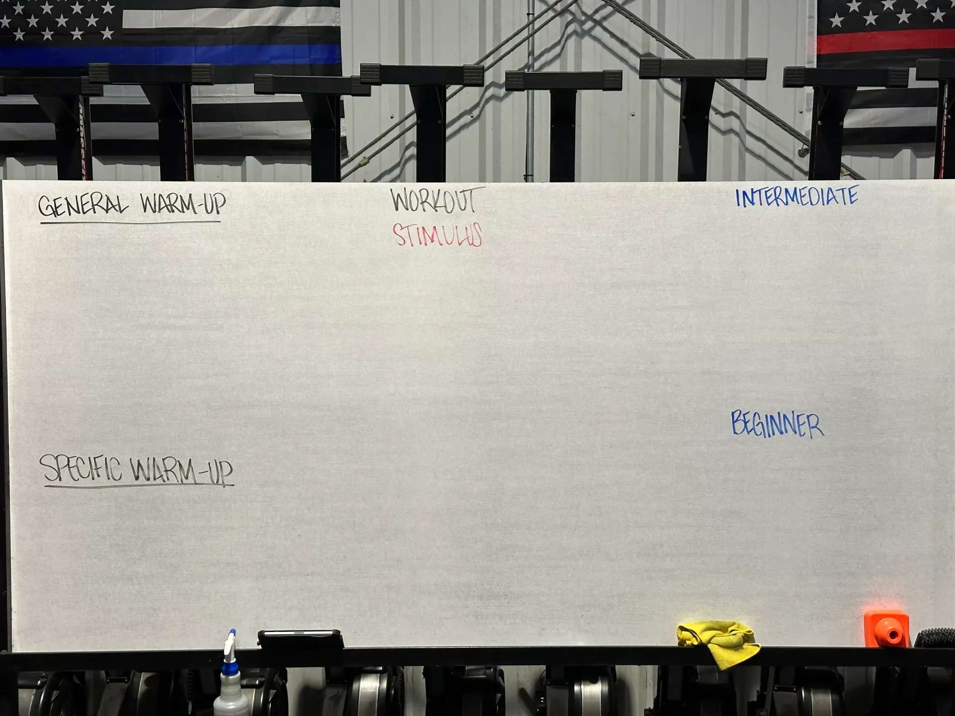 Whiteboard with handwritten notes and colored labels at CrossFit Exile in Moore, OK