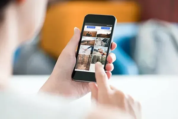 A person is holding a cell phone in their hand.