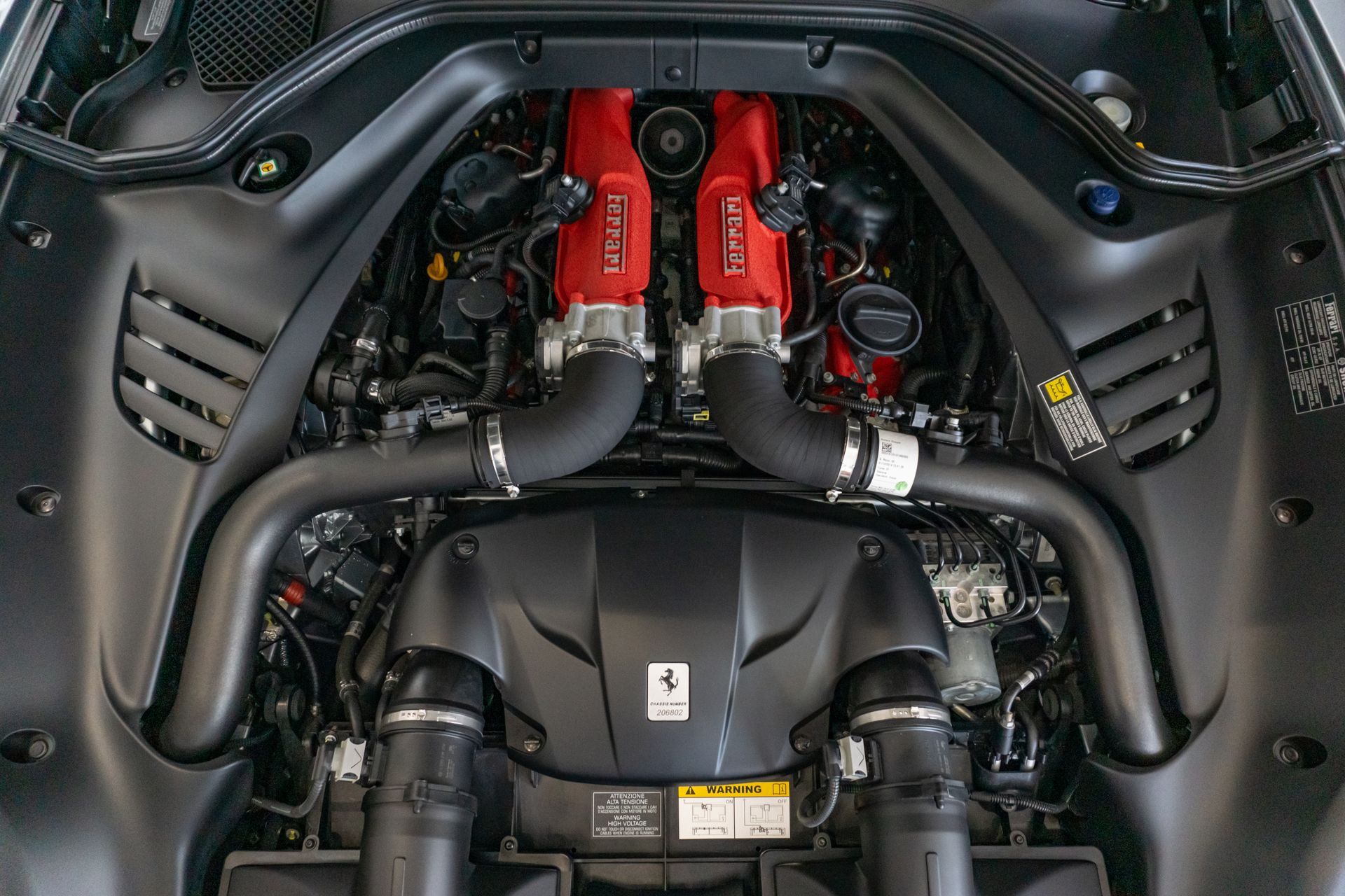 A close up of the engine of a ferrari car
