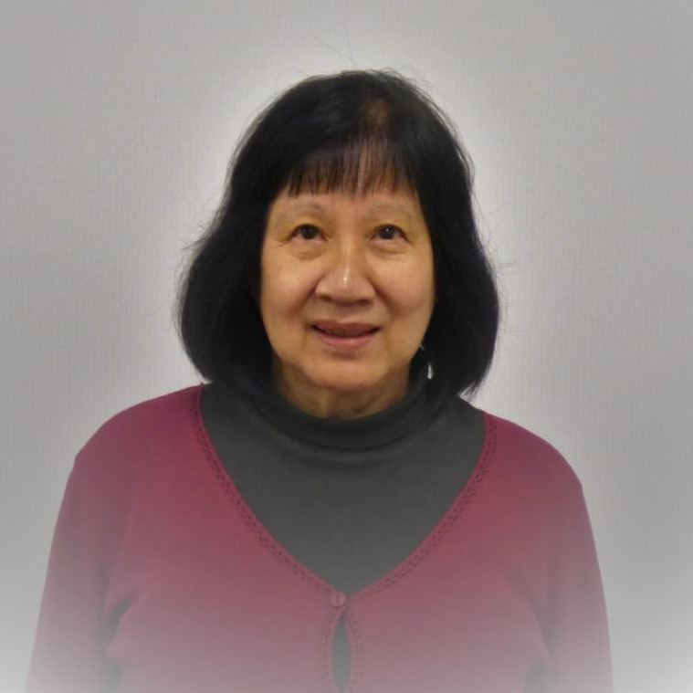 A woman in a red sweater is smiling for the camera
