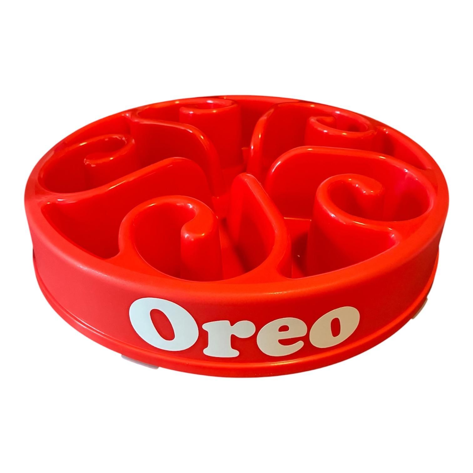 Rood, rond hondenspeeltje met Oreo-logo en vier gebogen vakjes voor snoepjes.