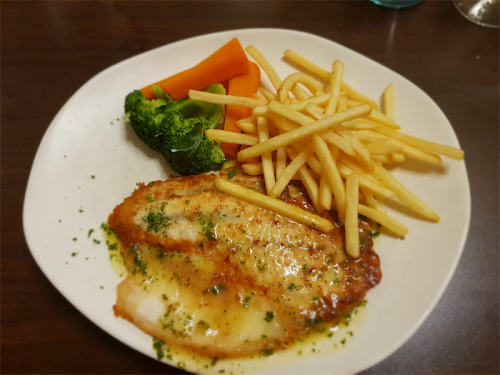 a plate of food with french fries broccoli and carrots