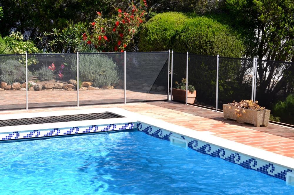 A Large Swimming Pool With A Fence Around It — Tuncote Concrete Constructions in Salamander Bay, NSW