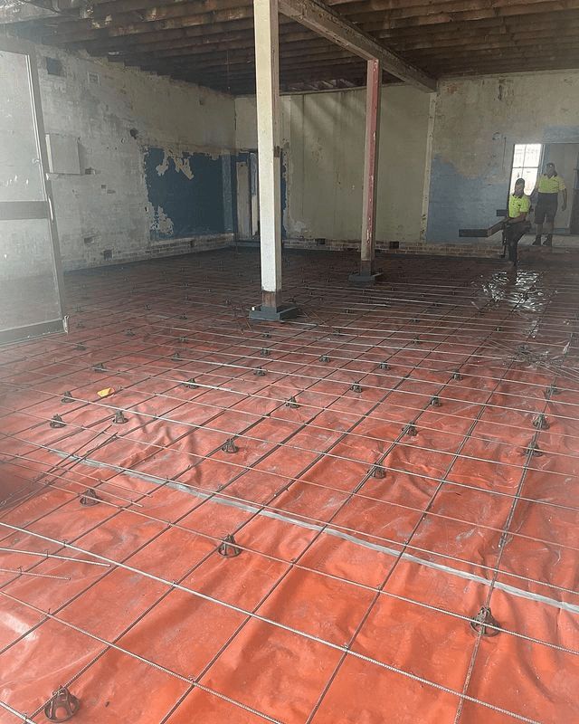 A Room With A Concrete Floor And A Red Tarp On The Floor — Tuncote Concrete Constructions in Salamander Bay, NSW