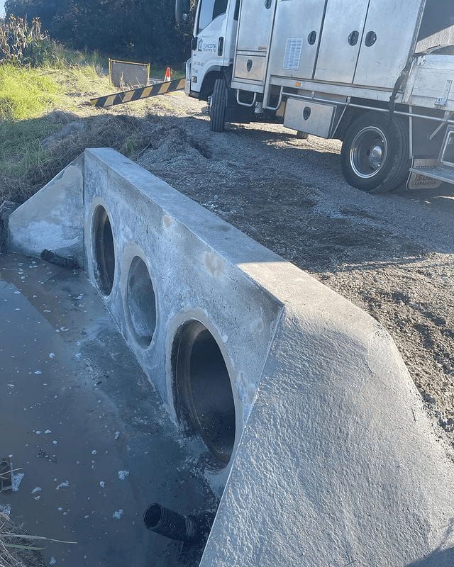 A Truck Is Parked On The Side Of The Road Next To A Concrete Wall — Tuncote Concrete Constructions in Nelson Bay, NSW