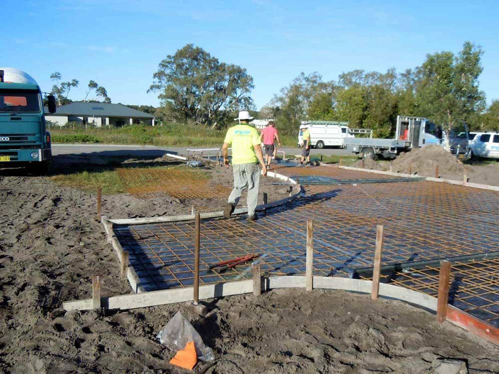 A Group Of Construction Workers Are Working On A Construction Site — Tuncote Concrete Constructions in Anna Bay, NSW