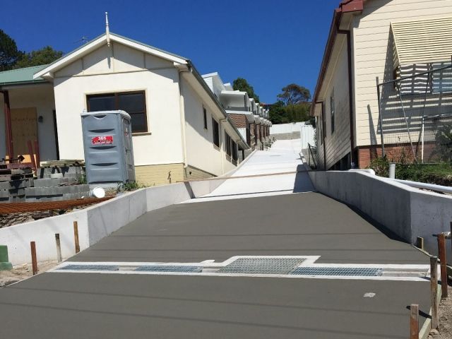 A Concrete Ramp Is Being Built Between Two Houses — Tuncote Concrete Constructions in Salamander Bay, NSW
