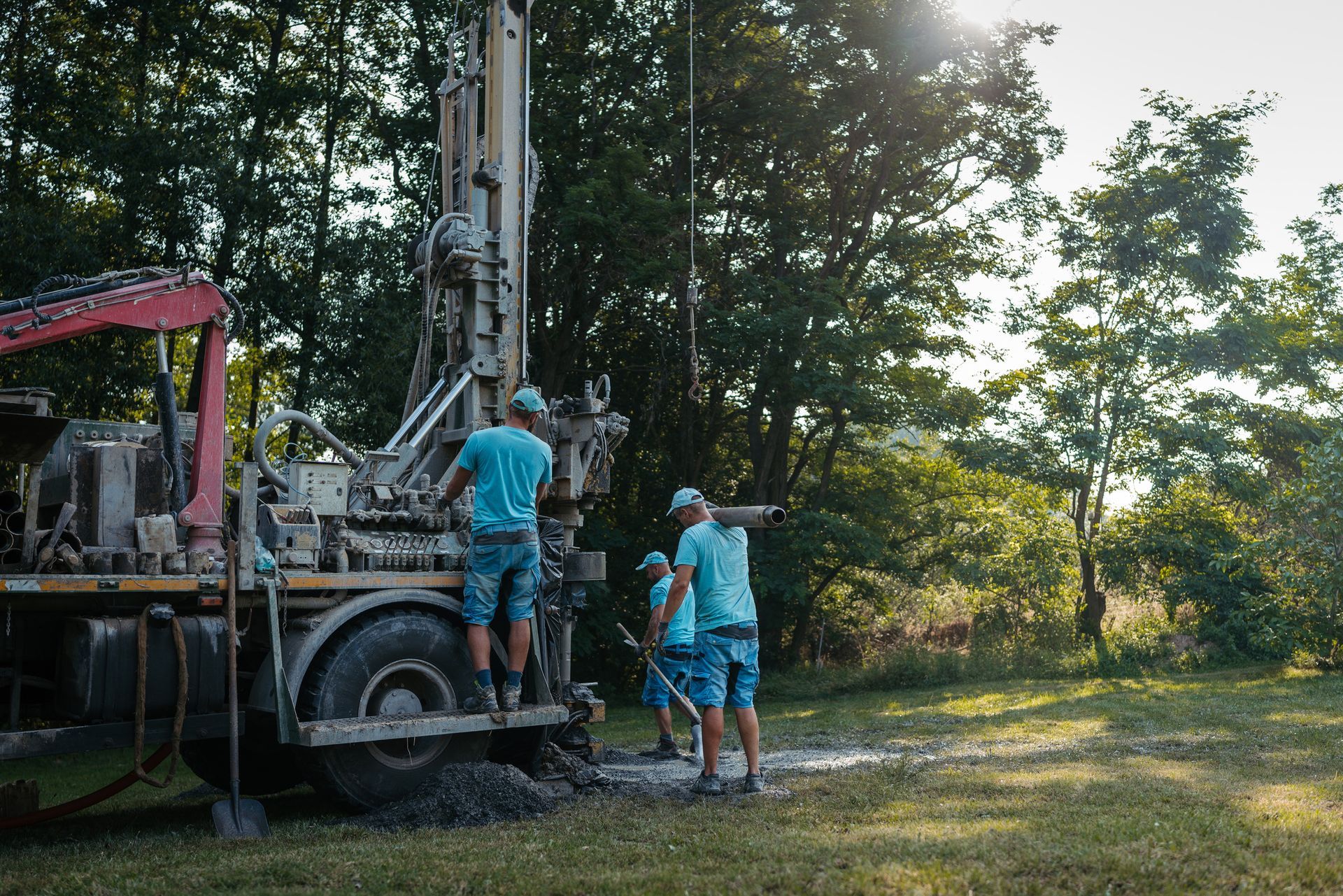 Well drilling team using advanced drilling rig for professional water well services.